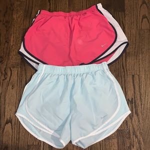 two pairs of nikes running shorts
